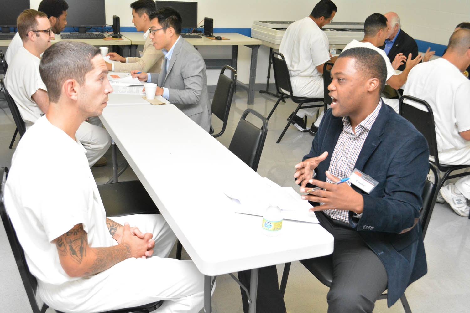 Charles J. Blain in conversation during a Prison Entrepreneurship Program visit